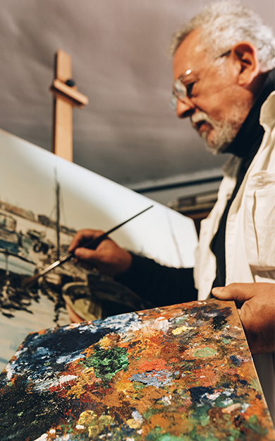 man painting on easel