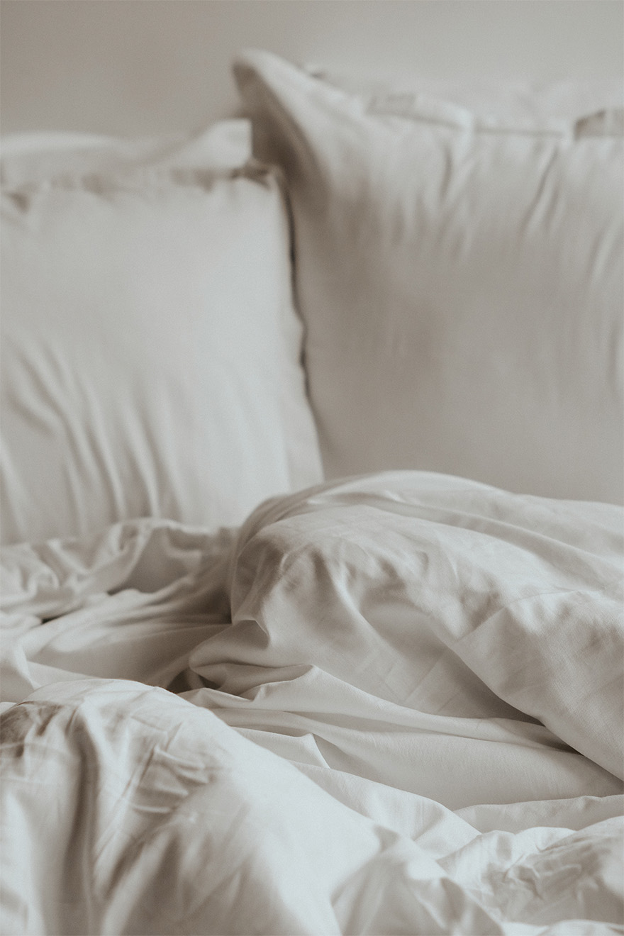 bed with white pillows and sheets