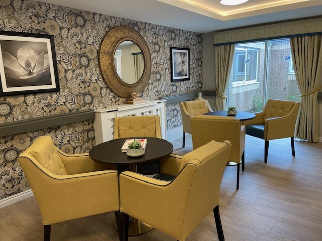 care home reception area with armchairs and tables