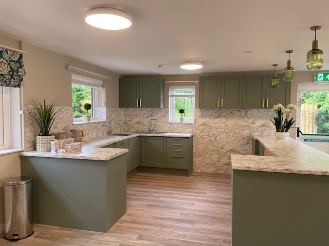 An Activities of Daily Living Kitchen and Life Skills Space with sage green counters